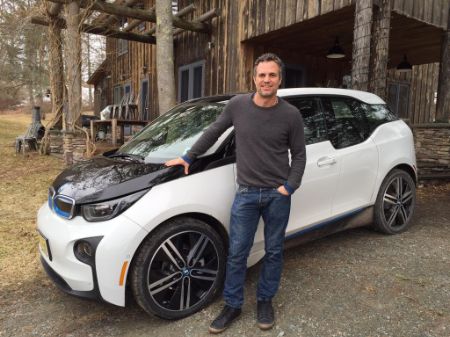 Mark Ruffalo giving a pose infront of his car.